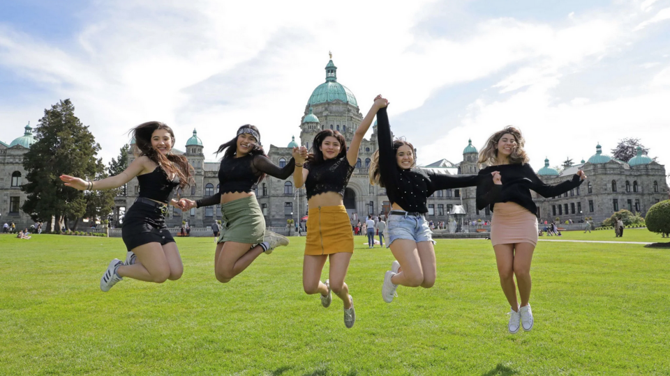 Five females jumping infront of the Legislative Assembly of British Columbia in Victoria, BC